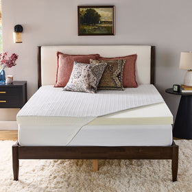Novaform Advanced Back Support Plus Mattress Topper placed on a mattress with the knit cover pulled back to reveal one corner of the Luracor support foam topper.