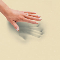 Woman's hand lifted up from pressing down on the gel memory foam with her hand imprints still seen in the foam layer