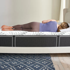 Side view of a woman lying on the Novaform Serafina Mattress, showing the pressure relieving comfort.