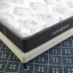 An aerial view of the front corner of the Serafina Mattress, showing the white quilted cover with abstract gray leaf pattern.