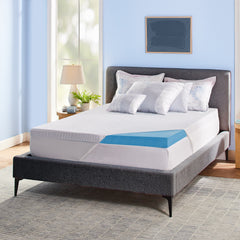 Novaform Soothing Cool Plus Mattress Topper placed on a mattress with the knit cover pulled back to reveal one corner of the gel memory foam topper.