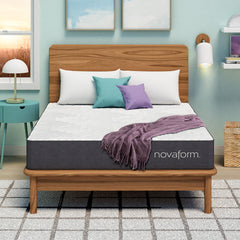 Front view of the Novaform DreamAway 8 Inch Gel Memory Foam Mattress complete with white, teal and purple pillows and a purple throw blanket
