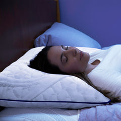 Young woman asleep lying on her back with her head resting on the ComfortGrande Foam Pillow