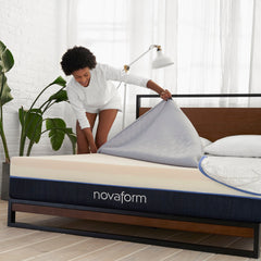 Young woman removing the unzipped SoFresh Mattress cover and revealing the layers of tan LURAcor uplifting foam and responsive gel memory foam