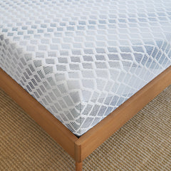 Close up corner view of the tailored gray and white cover on the Advanced Back Support Mattress