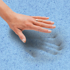 Woman lifting her hand up from gel memory foam with the indents of her handprint still seen on the foam