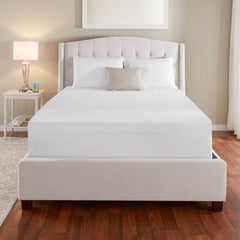 Front view of a bed made up with the EVENcor GelPlus Topper slip cover pulled entirely over the mattress and complete with white and beige pillows