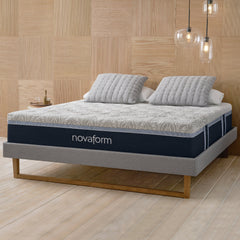 Angled front view of the Novaform Serafina Pearl Cool Comfort Gel Memory Foam Mattress complete with gray and white pillows