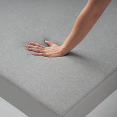 Woman's hand pressing down on the SoFresh Topper to show the responsive support of the memory foam