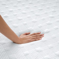 Woman's hand pressing down on the ComfortLuxe Topper to show the responsive support of the memory foam